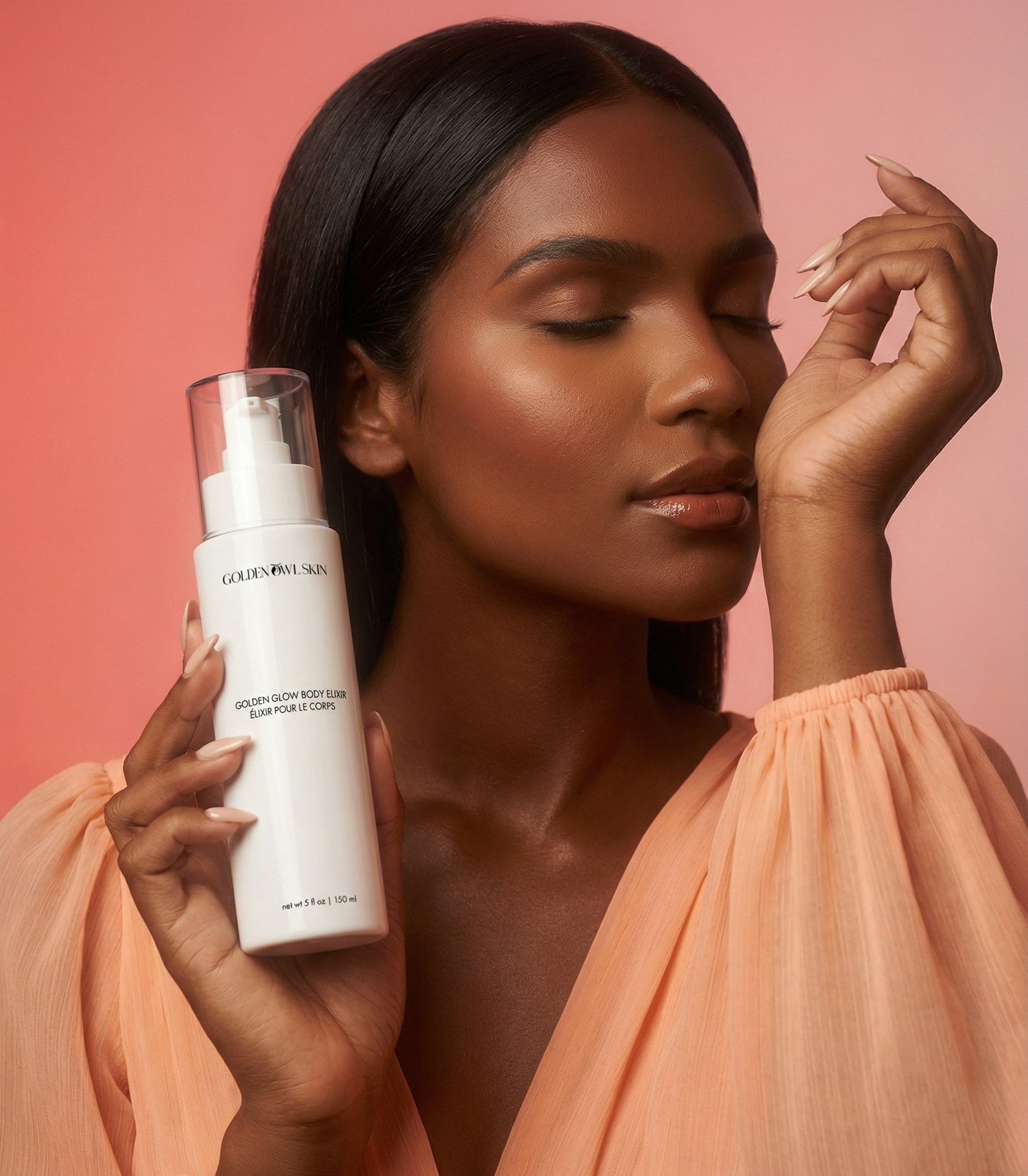 Woman holding a skincare product against a pink background